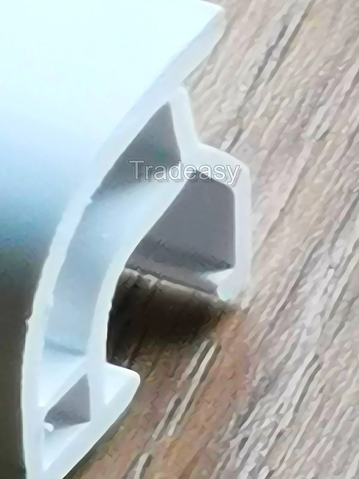 White plastic window or door gasket on wooden surface, replacement glazing seal