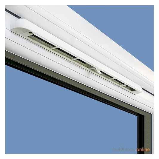 White 400mm trickle vent fitted to the head of a uPVC window frame against a blue sky