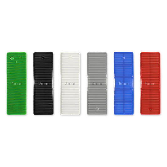 Flat plastic glazing packers, 32mm x 100mm, in six thicknesses from 1mm green to 6mm red.